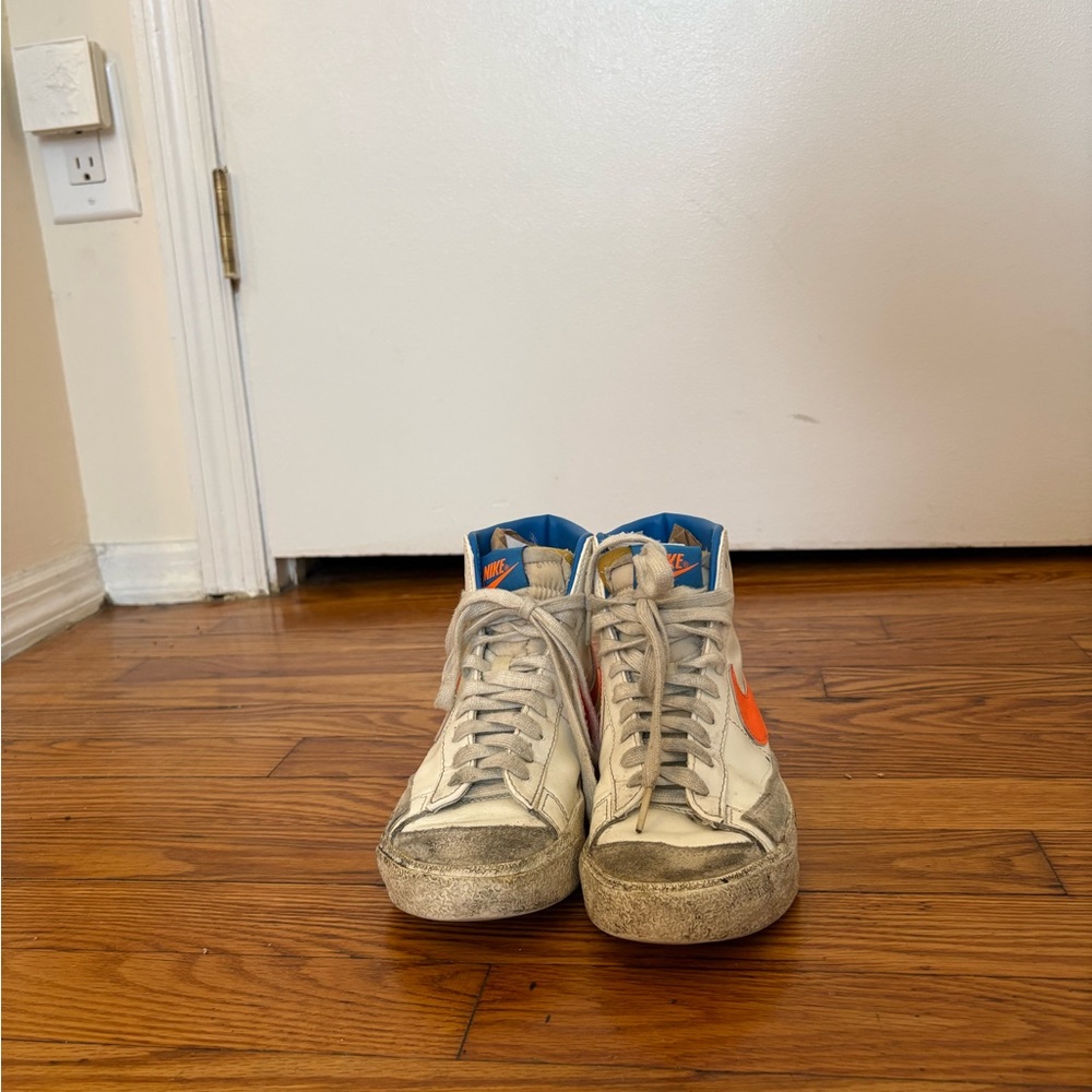Nike White High-Top Sneakers with Orange Swoosh and Blue Lining